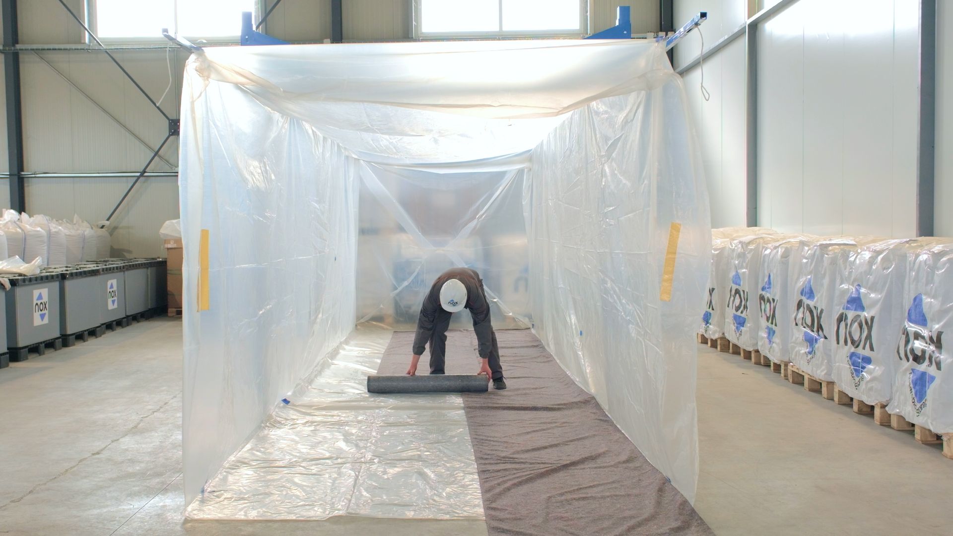 Operatore Nox stende telo protettivo a pavimento per installazione Mega Bag ermetico Operatore Nox stende telo protettivo a pavimento per installazione Mega Bag ermetico